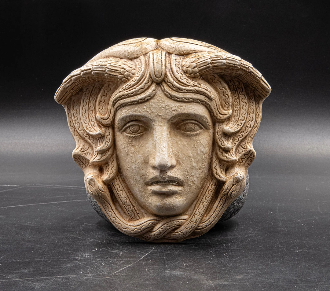 Head of Medusa with wings and serpents, following the iconographic type of the beautiful Gorgon developed in Classical art. Contemporary resin replica. Image by GreekMythos.