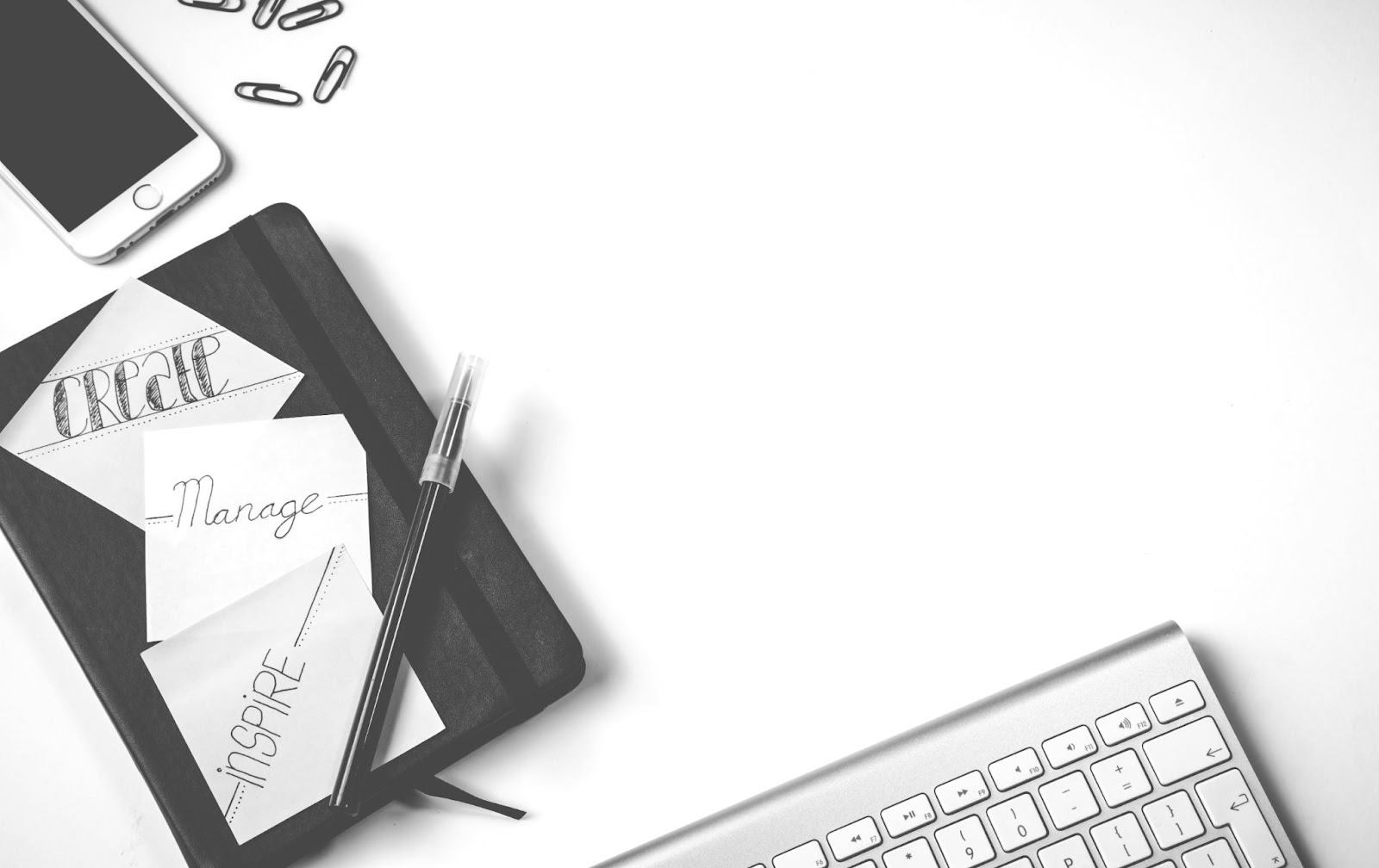 Desk with phone, keyboard, and notepad