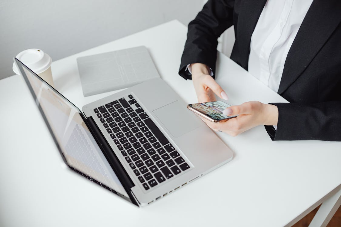 Person using a phone sat at a table