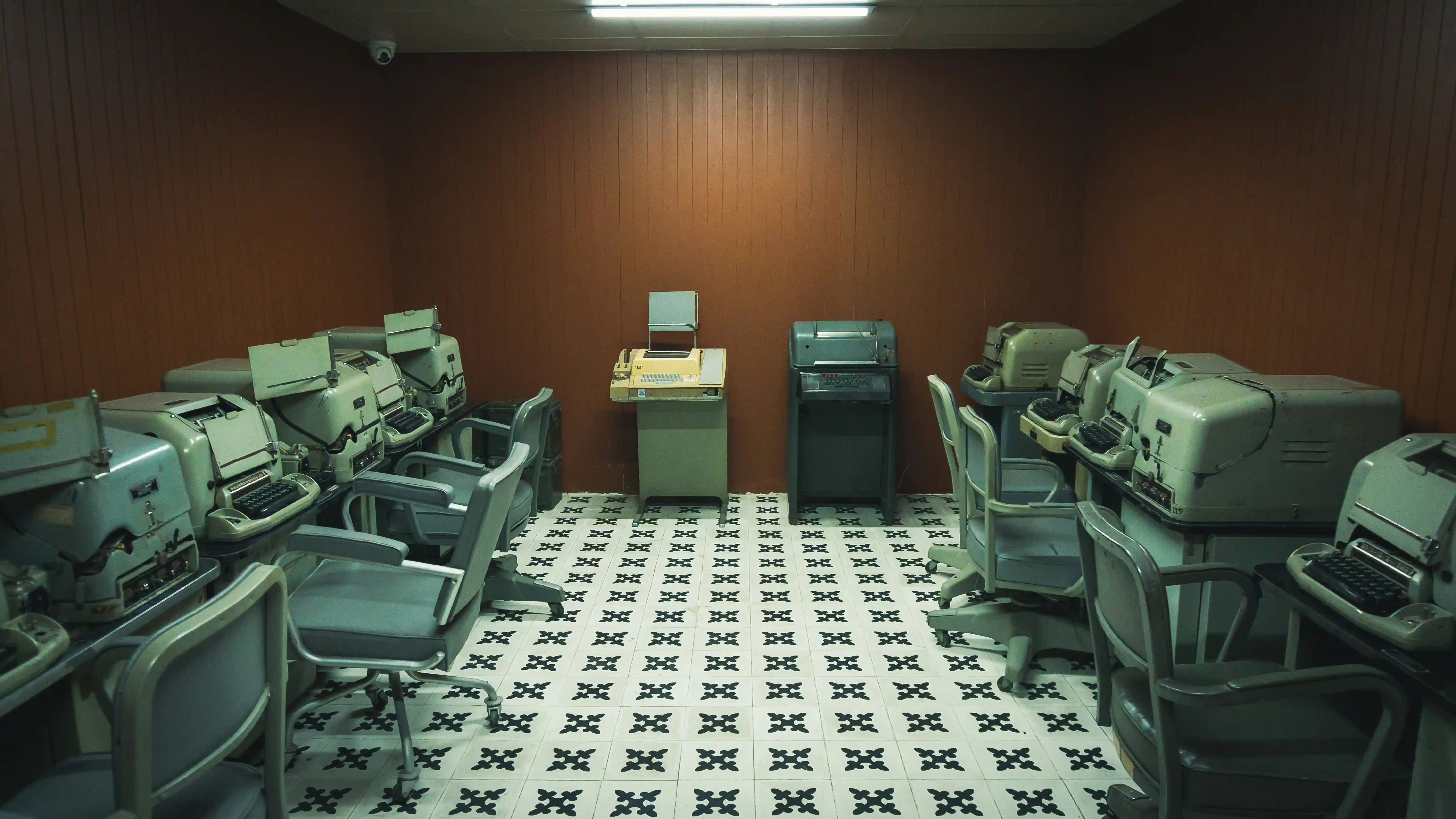 Office in the 60s with fluorescent lights and standardized desk setup