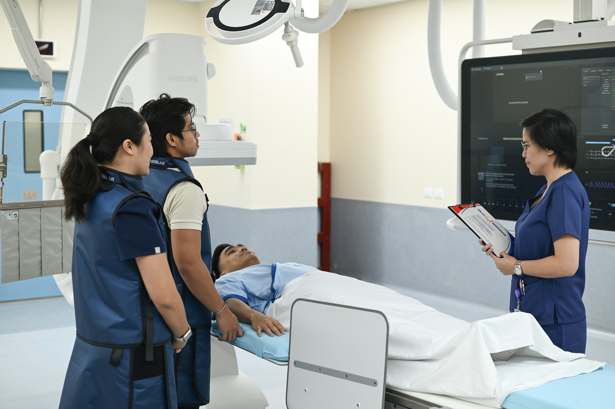 Doctors and nurses attending to a patient in hospital bed