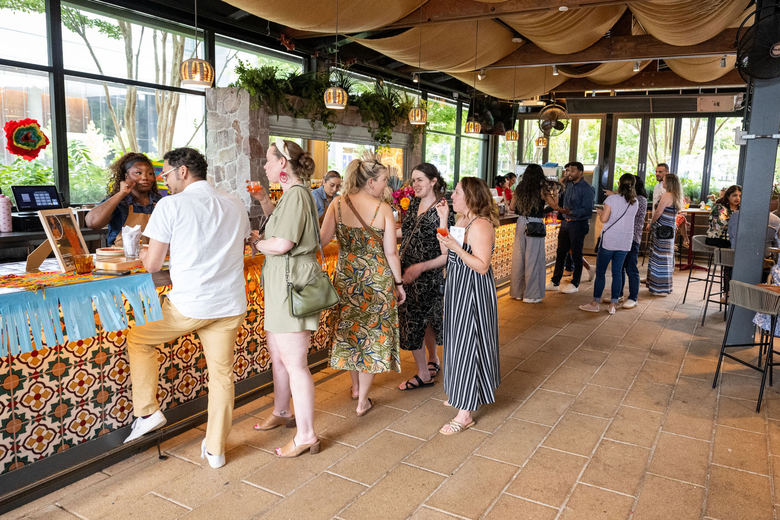 Guests lining up at restaurant tasting stations inside Ometeo at Capital One Center Culinary Week 2026