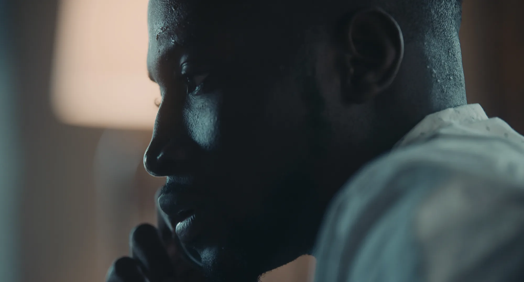 17 Year Locust film still showing the young Haitian man Renee speaking on a cell phone
