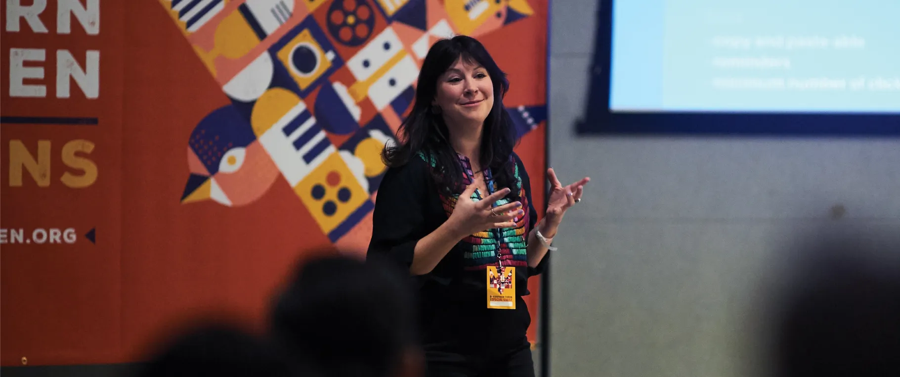 southern screen photo showing woman speaking to audience with southern screen poster in the background