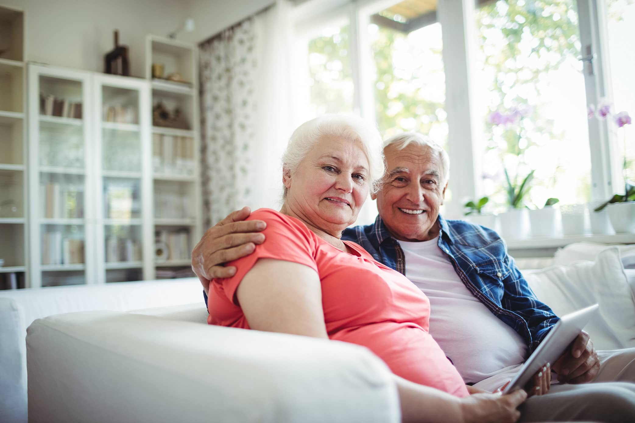 an elderly couple smiling toward the camera