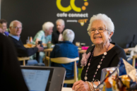 Consumer smiles as she is ordering a coffee from Cafe Connect