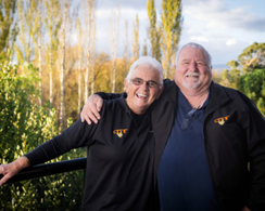 an elderly couple smiling toward the camera