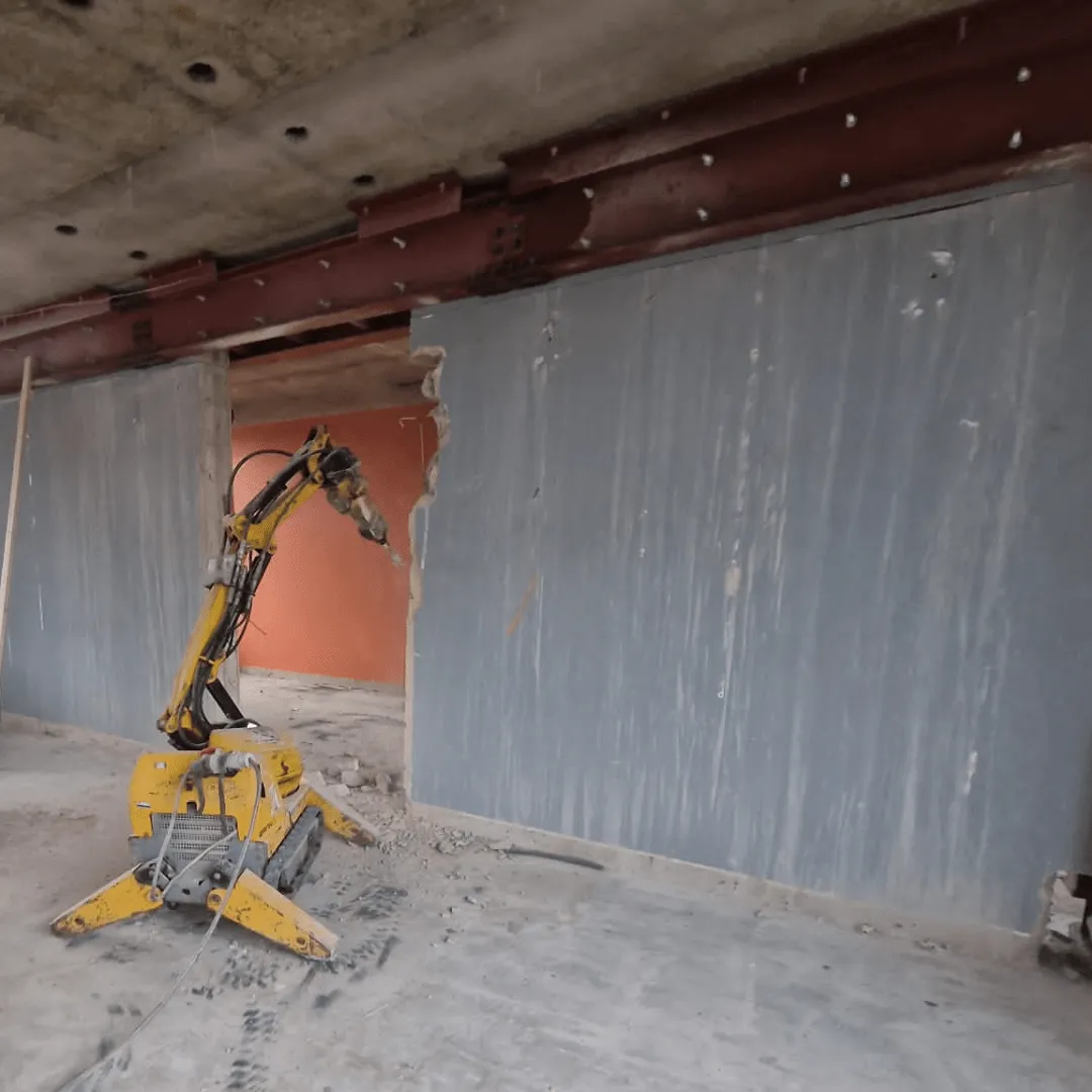 Brokk demolition robot demolishing a wall