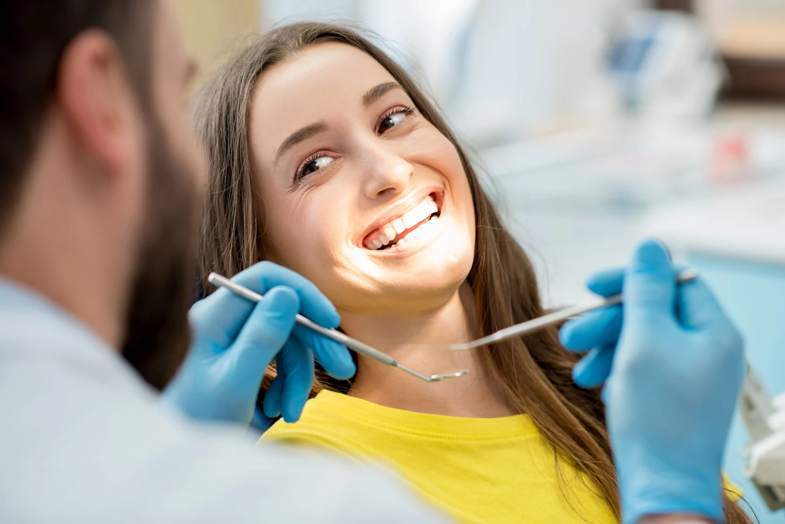 Adult patient smiling during a teeth straightening consultation at a dental practice in Gloucester 