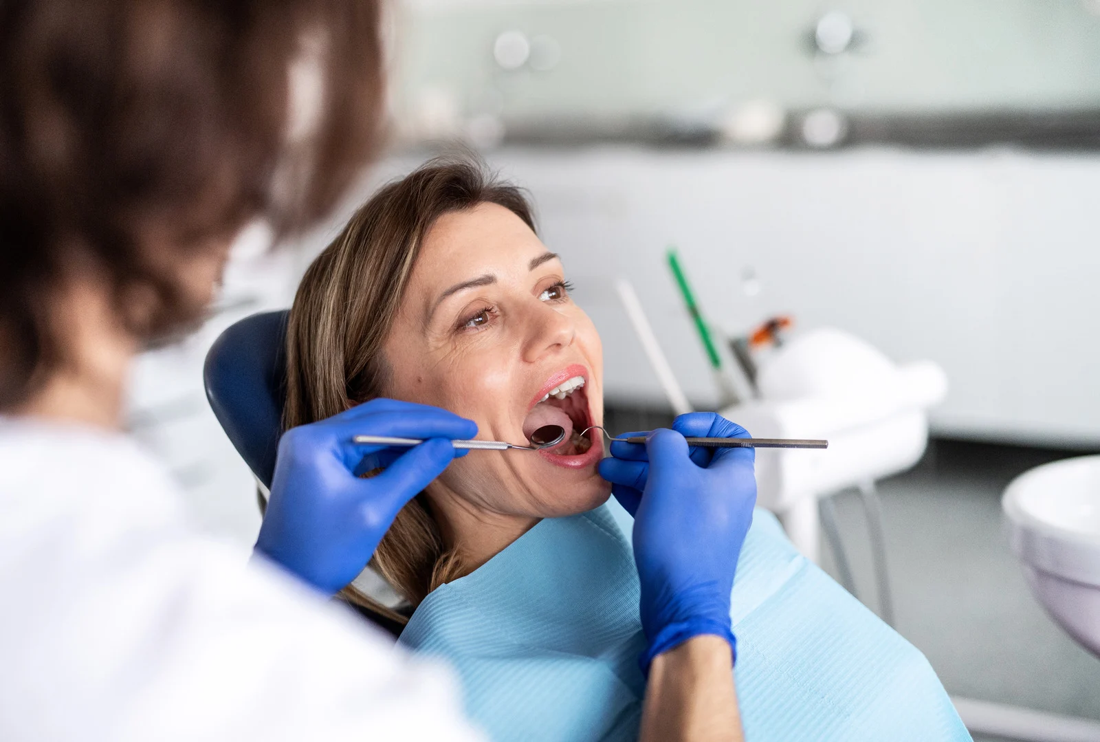 Patient having a dental examination with mirror and probe at Limes Dental Practice in Gloucester
