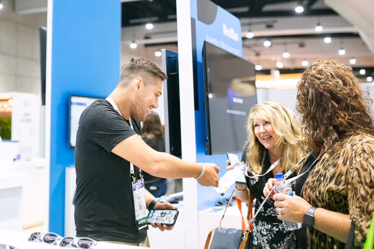 ResMan employee scanning a badge at the NAA trade show booth