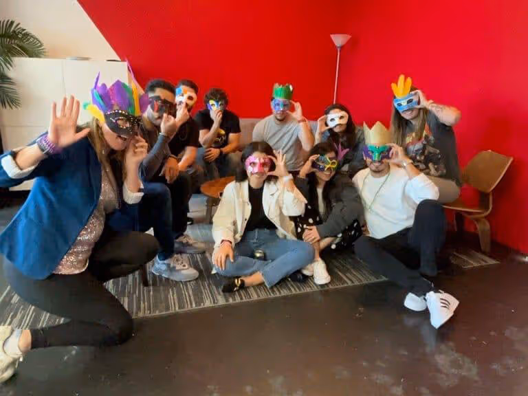 ResMan team members wearing Mardi Gras masks