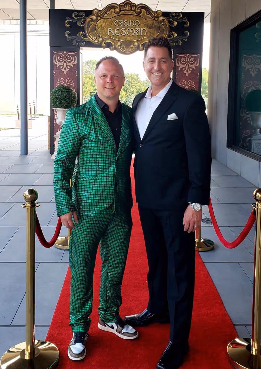 Two ResMan employees posing outside the ResMan Casino at ResMania 2024