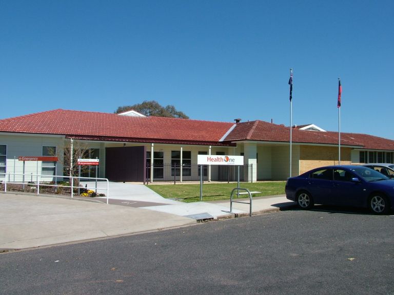 Picture of big modern building. blue sky and cars in the background. 