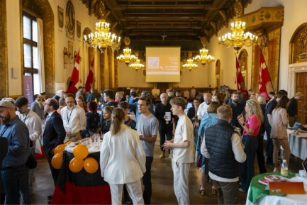 A group of people in a roomDescription automatically generated