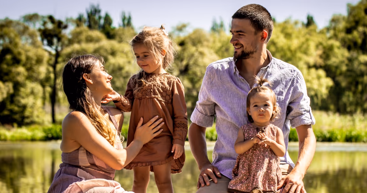 Foster family enjoying time together outdoors, representing safety, stability, and the supportive community foster care provides