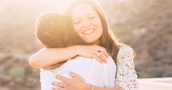 Foster carer and young person share a heartfelt hug – a true marker of fostering success.
