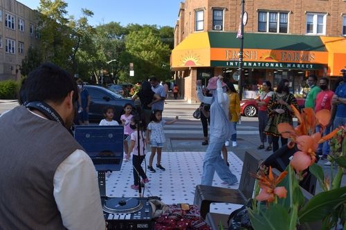 Image of a group of people dancing on a street corner on Devon Avenue