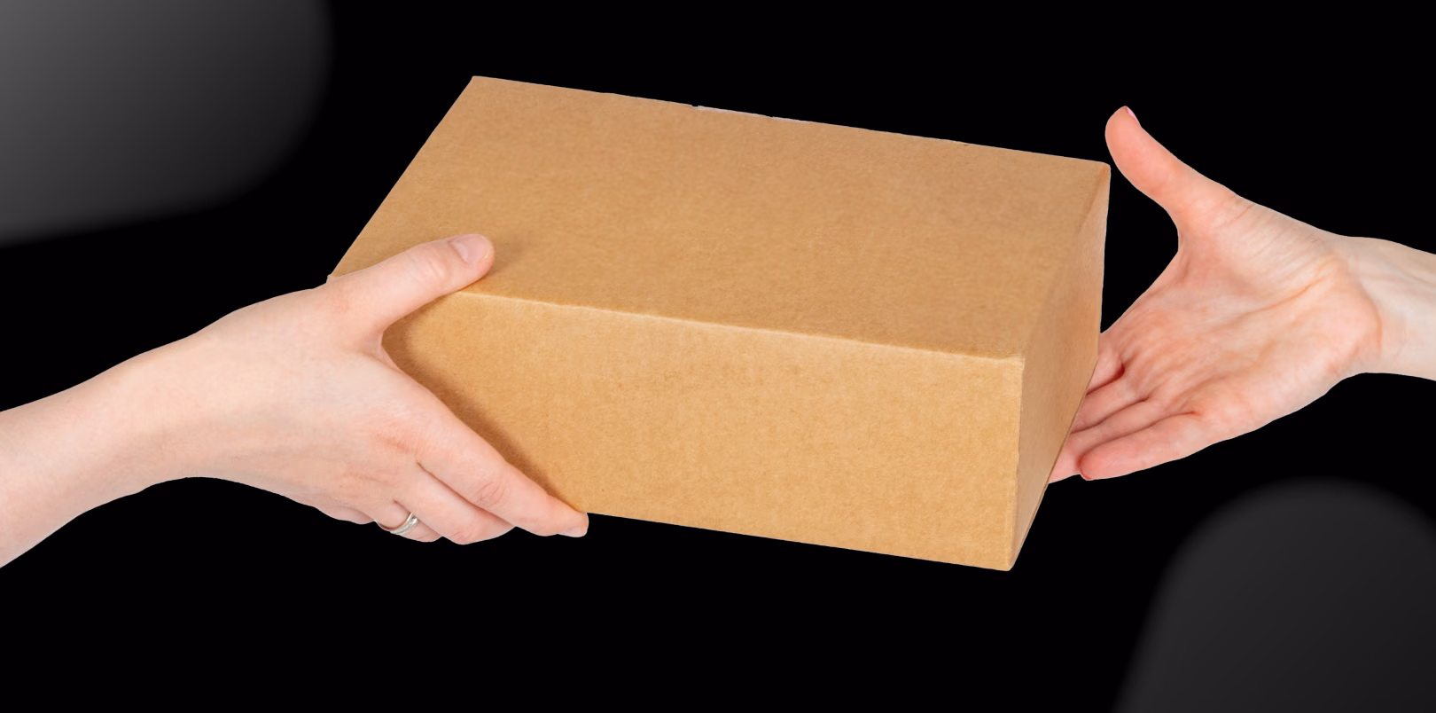 A stock photo of two hands holding a brown package box