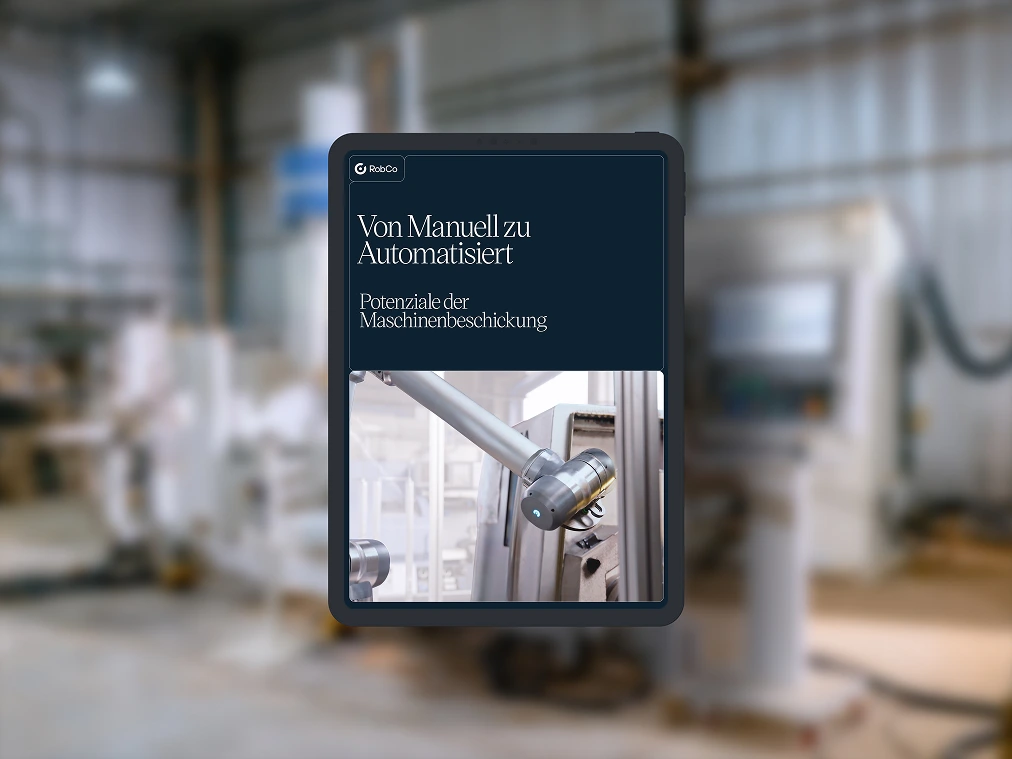 Whitepaper-Mockup mit dem Titel „Von manuell zu automatisiert - Potenziale der Maschinenbeschickung“. Hintergrundbild in einer industriellen Umgebung.