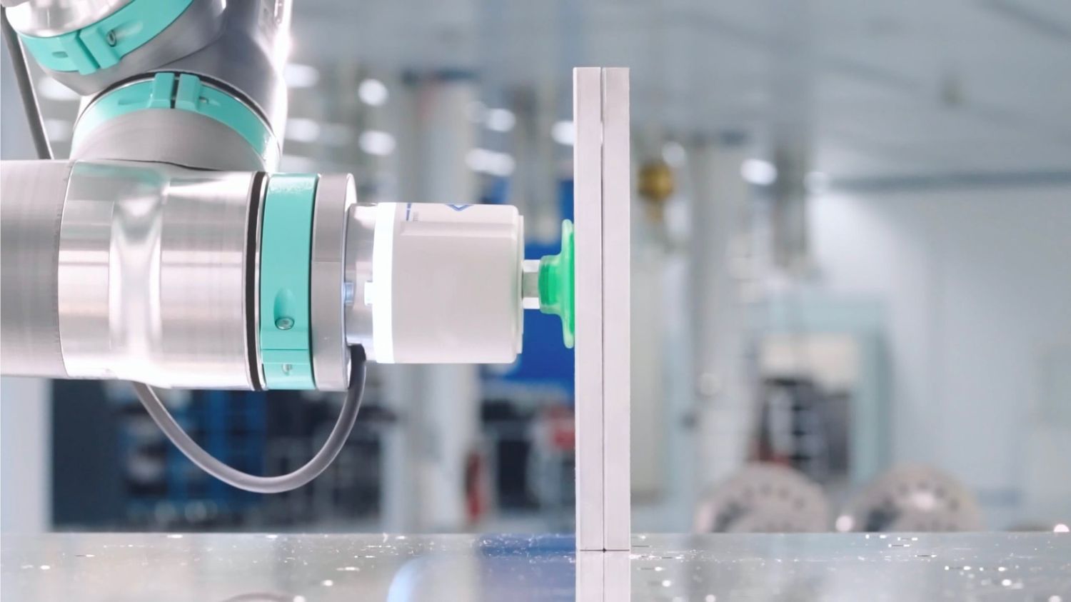 Ein Automatisierungs-Roboter führt mit einem speziellen Endeffektor eine präzise Oberflächenbehandlung an einem weißen Werkstück durch.