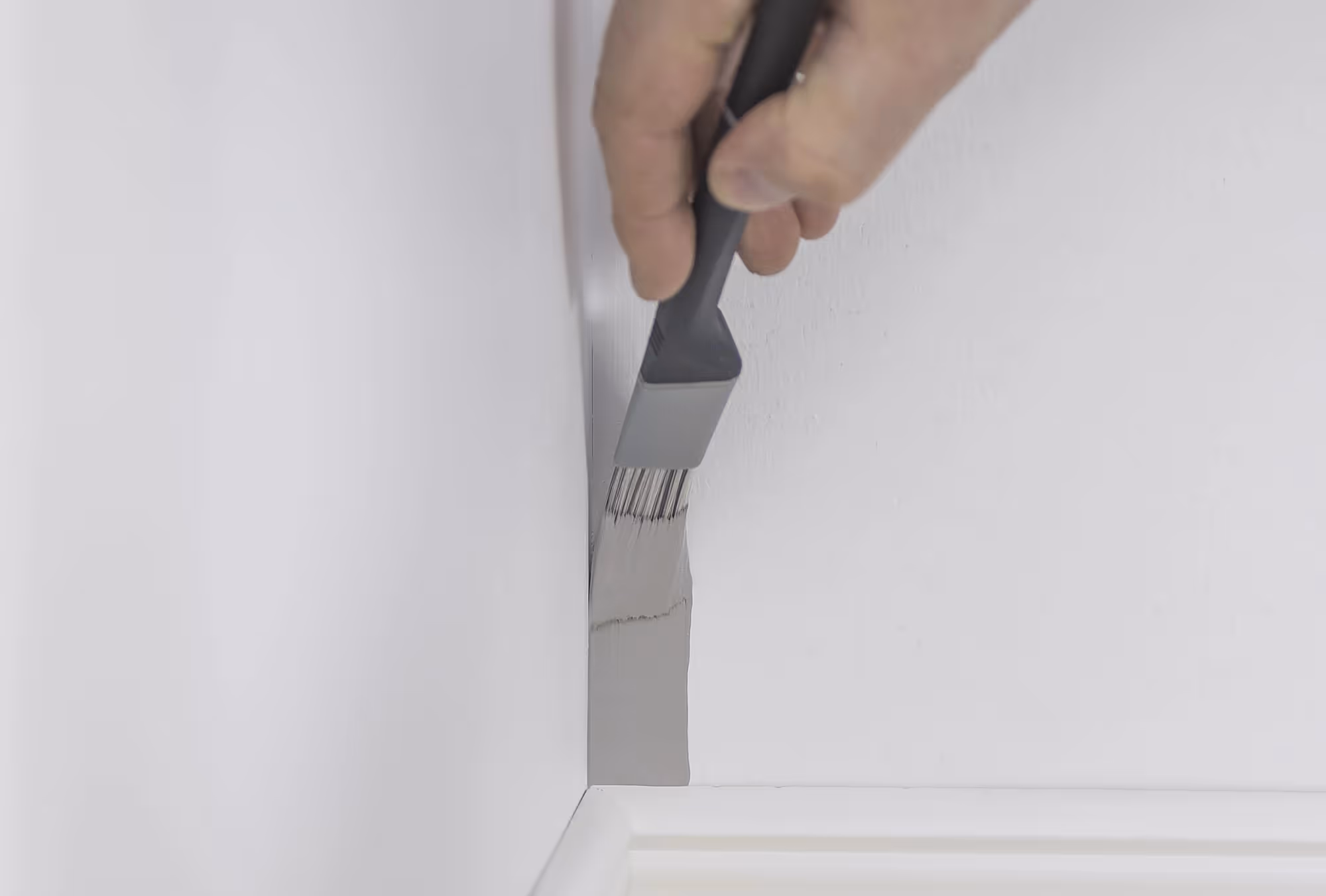 Paintbrush used to paint in a corner
