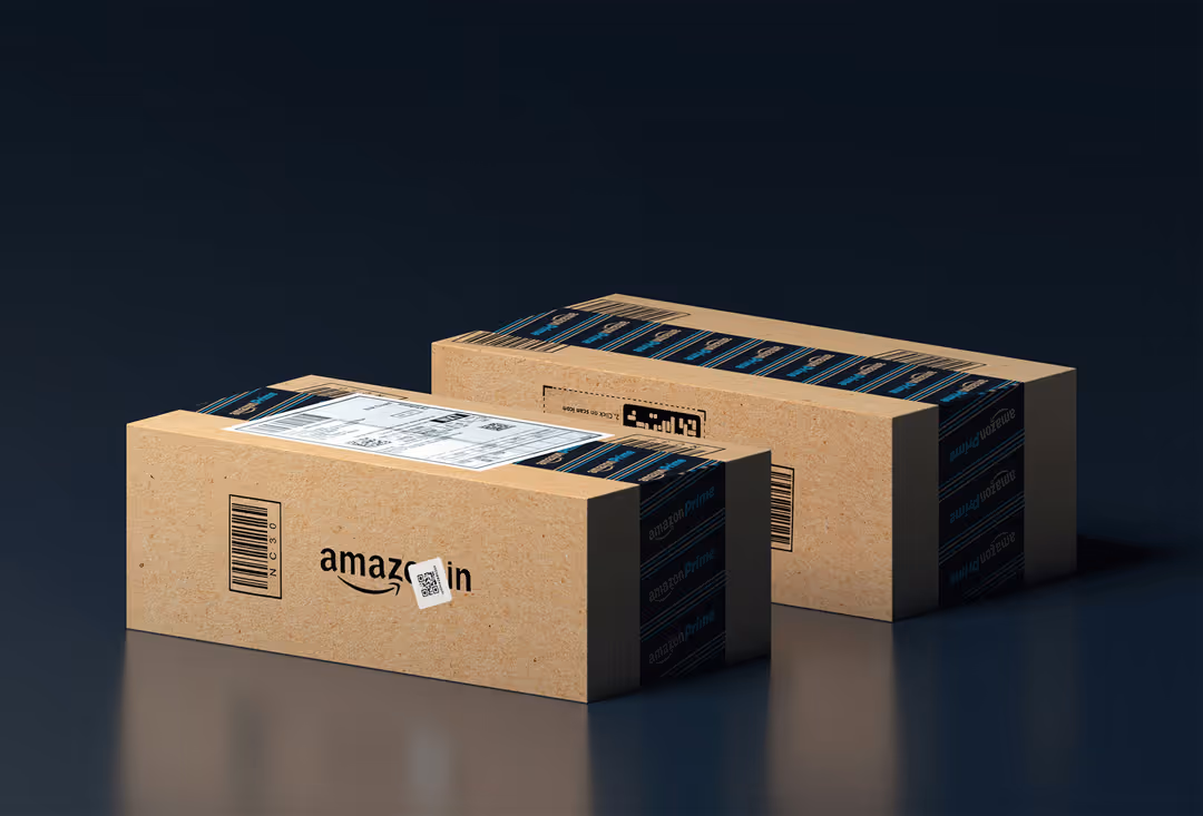 Two cardboard Amazon Prime shipping boxes sealed with Amazon Prime branded tape on a dark surface.