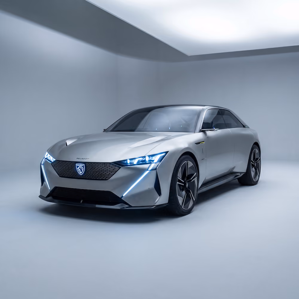 Silver modern Peugeot electric car with illuminated front lights in a minimal white studio.