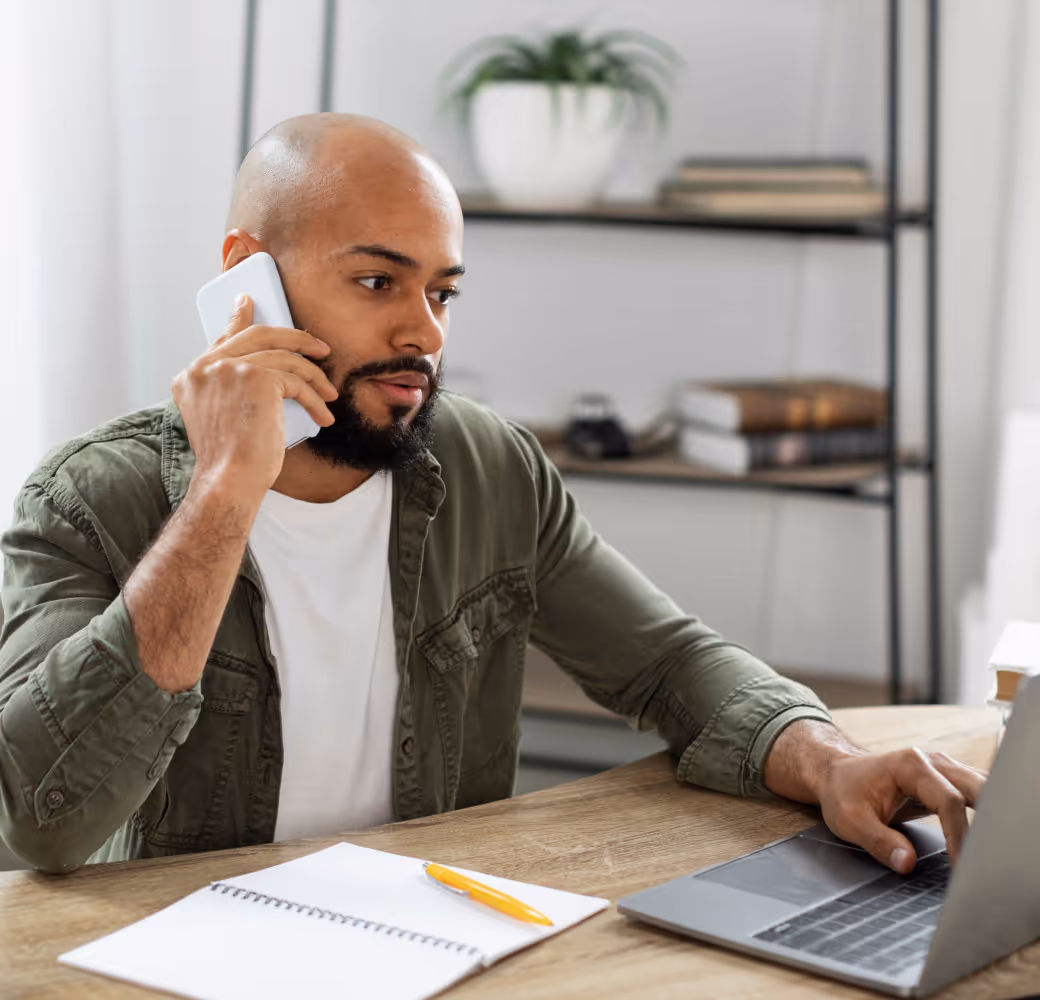 A young man, on his smartphone, calls a Tandem representative to discuss his financial challenges and enquire about potential options to manage and repay his outstanding loan.