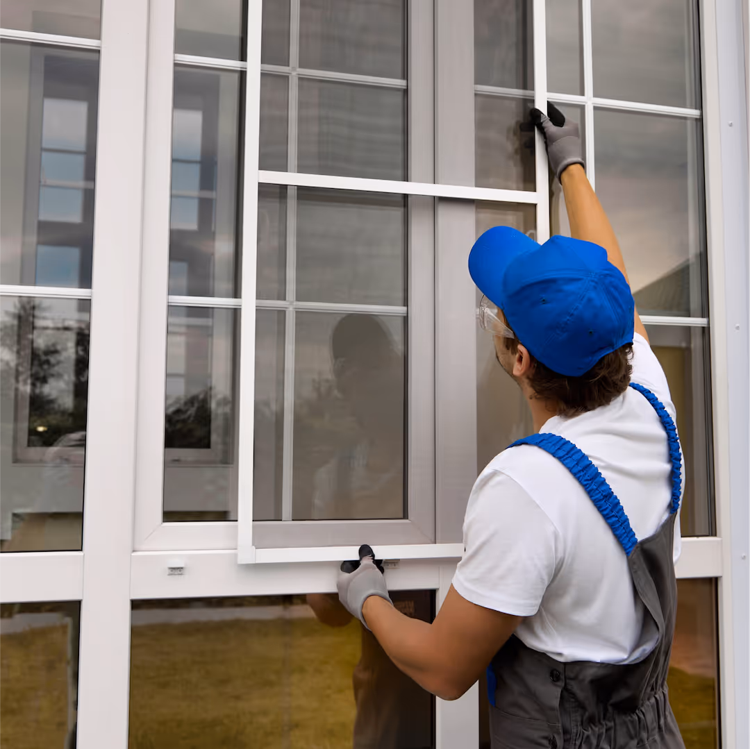 Windmill turbine in the middle of a green field, creating renewable enery for greener homes.