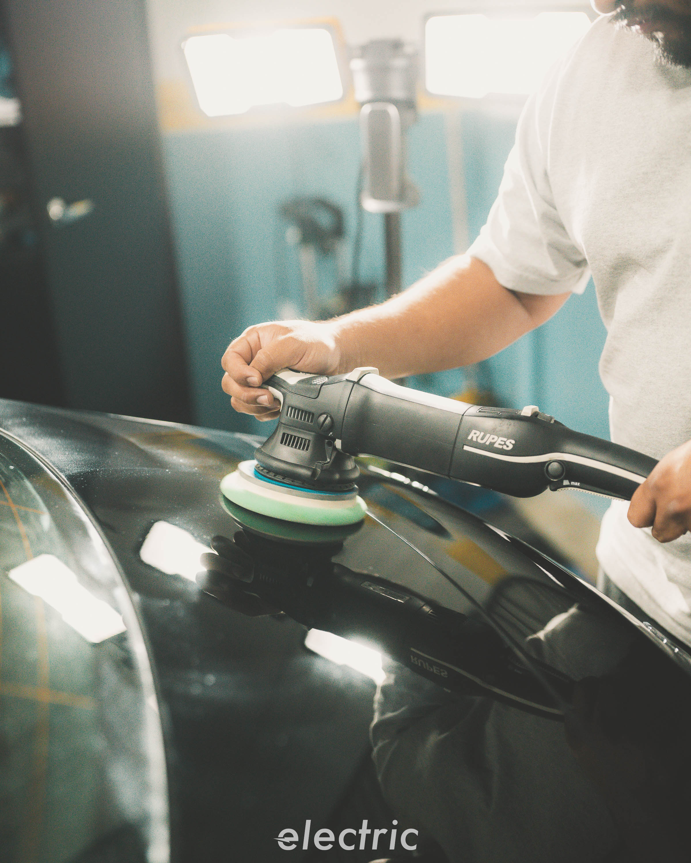 Machine polishing a Mercedes-AMG GT C during paint correction