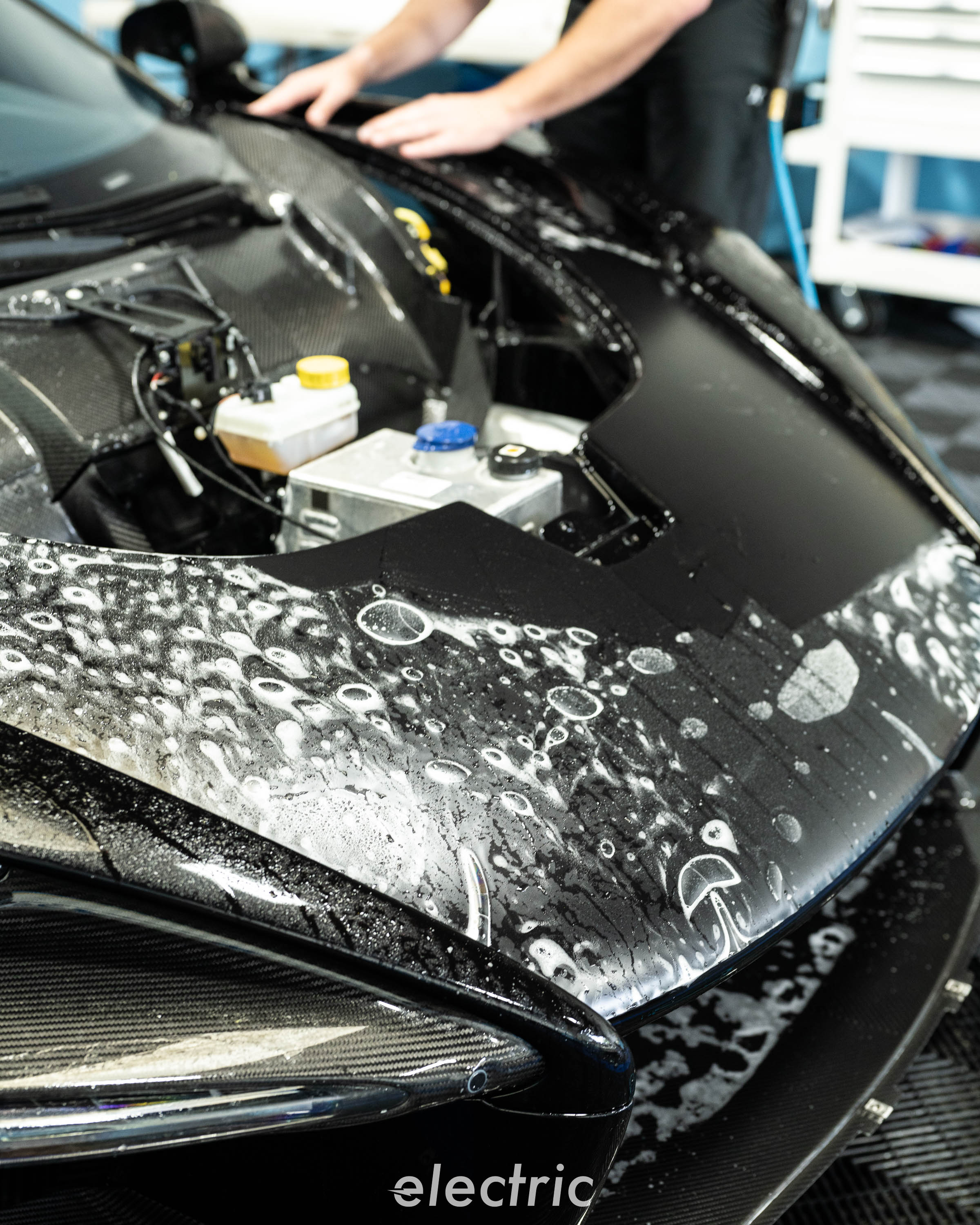 Installer laying paint protection film on a McLaren Senna