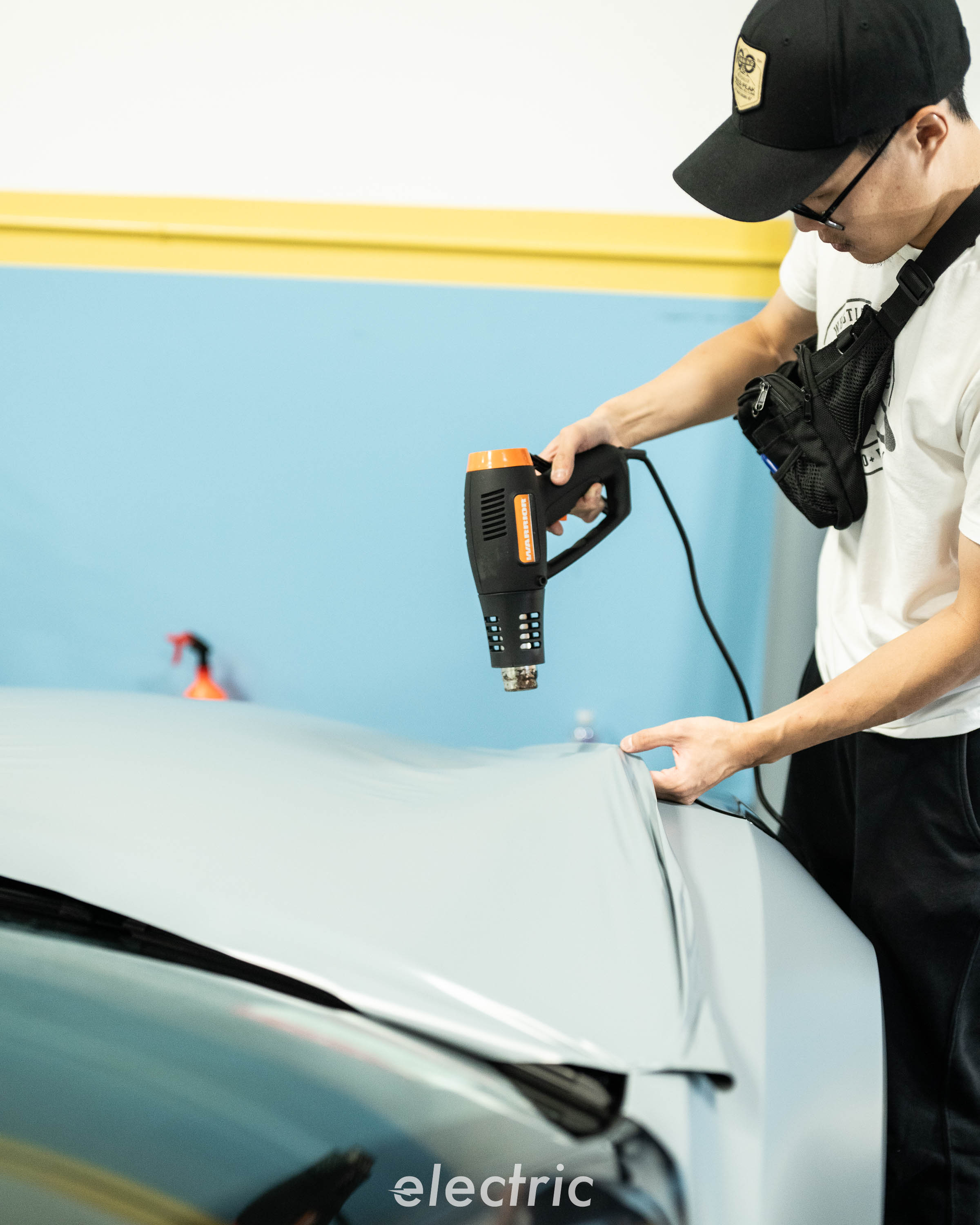 Installer heat-forming vinyl film on a Tesla Model 3