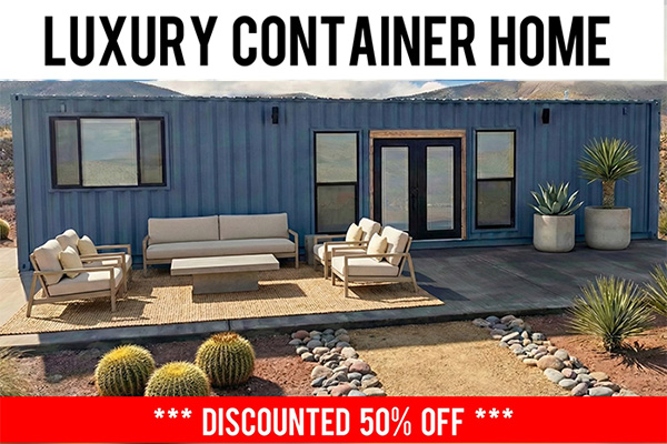 Modern luxury container home with outdoor patio furniture including sofa and chairs on a wooden deck, surrounded by desert landscaping with cacti and rocks.