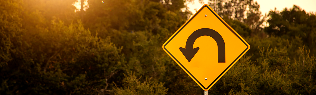 U turn sign representing salary overpayments