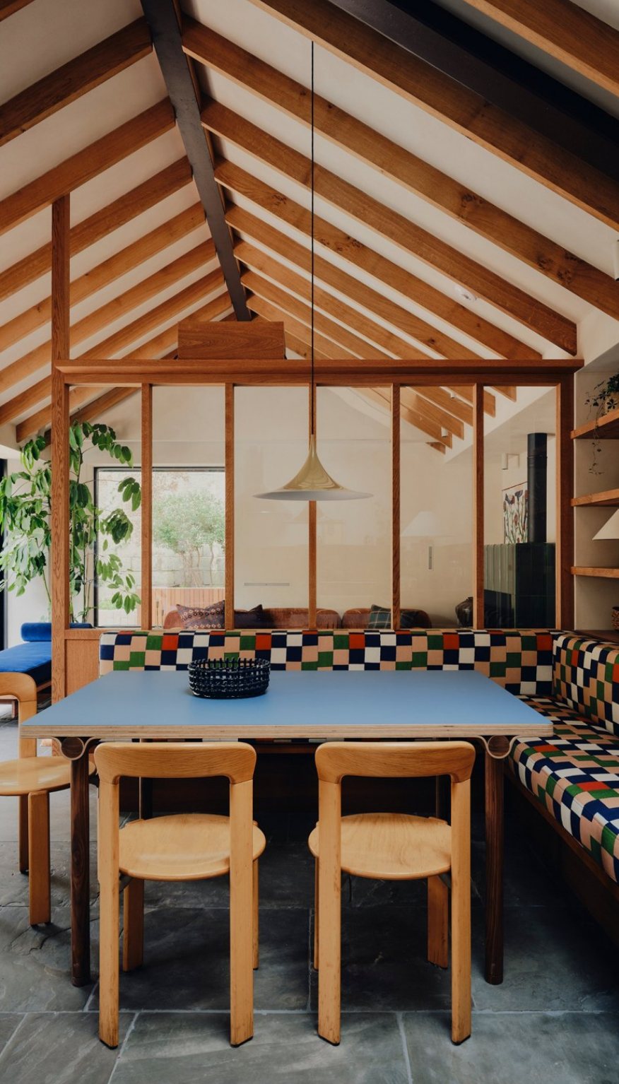 The finished pool house dining area under timber beams