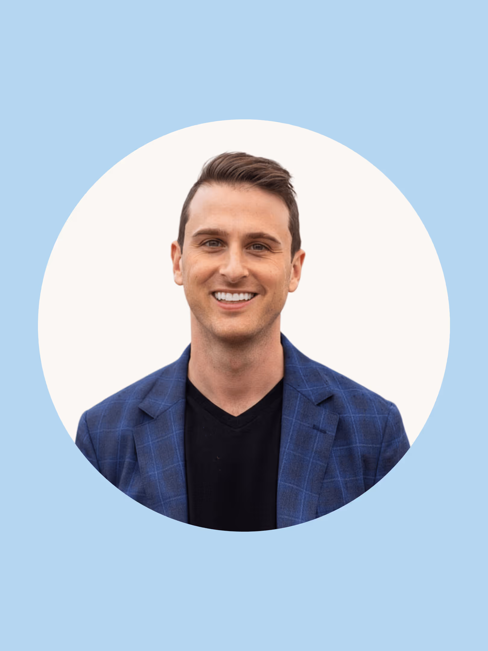 Smiling young man with short brown hair wearing a blue checkered blazer over a black shirt, against a white circular background with a light blue outer frame.