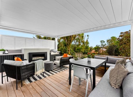 Outdoor living room with automated louvre, gas fireplace, and outdoor kitchen