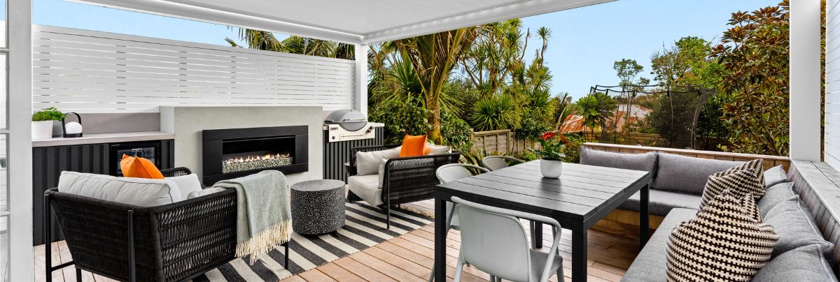 Outdoor living room with automated louvre, gas fireplace, and outdoor kitchen