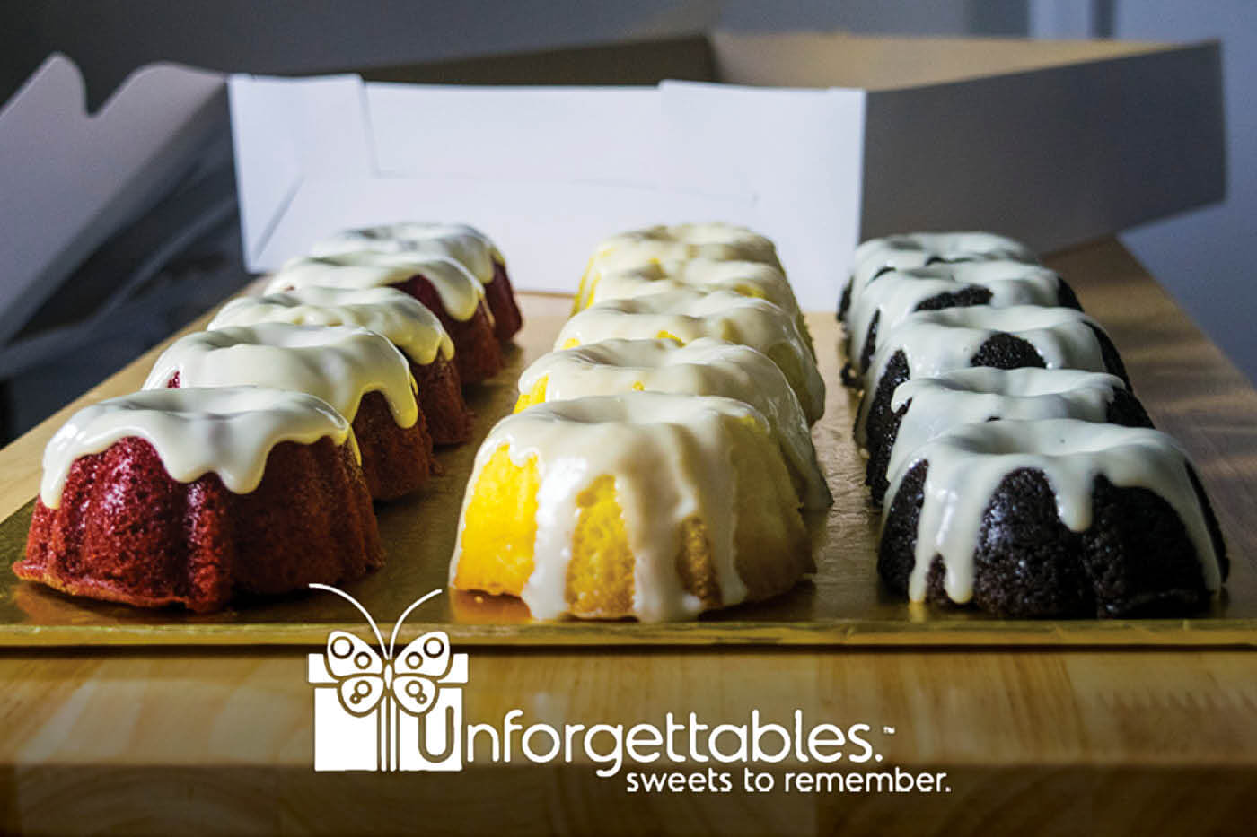Tray of multi-colored bundt cakes, Unforgettables logo
