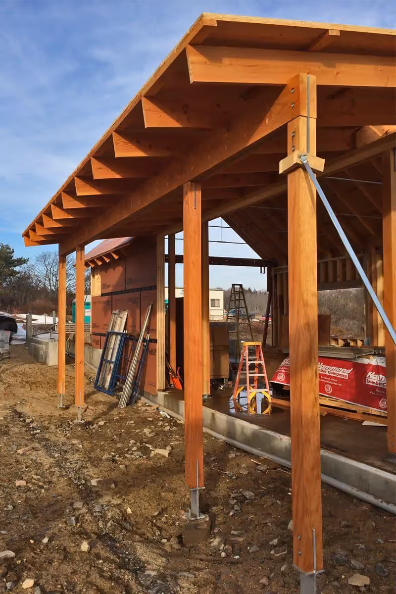 Wooden construction site with timber frame structure and construction materials