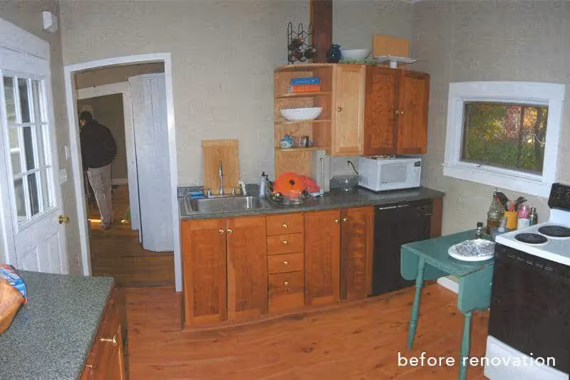 Vintage kitchen with wooden cabinets before renovation, showing appliances
