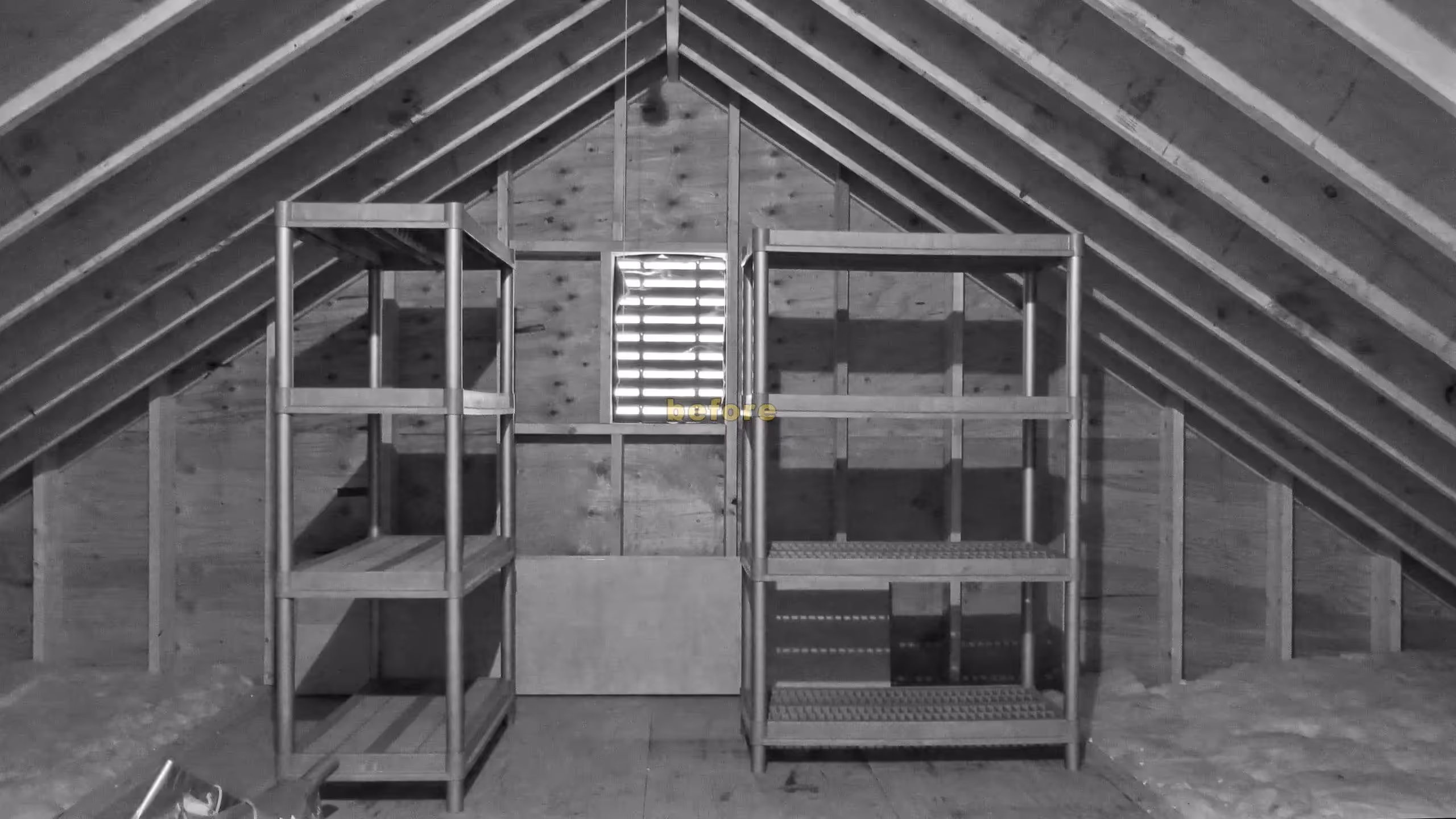 Metal shelving units in a wooden attic with a small ventilation window