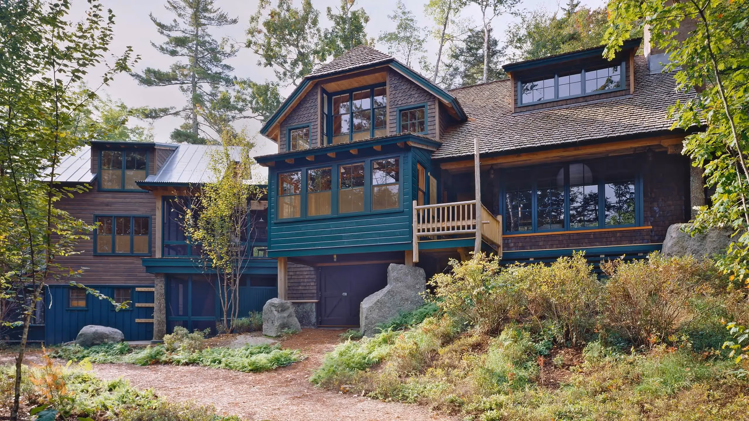 Rustic woodland cabin with green and wood tones nestled in forest