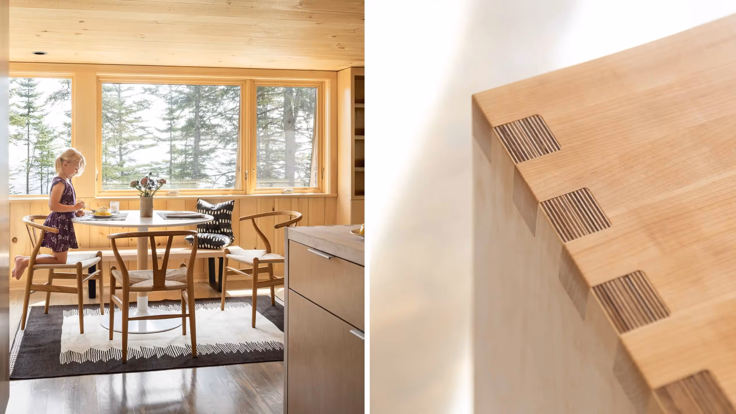 Wooden dining area with forest view and modern Wishbone chairs