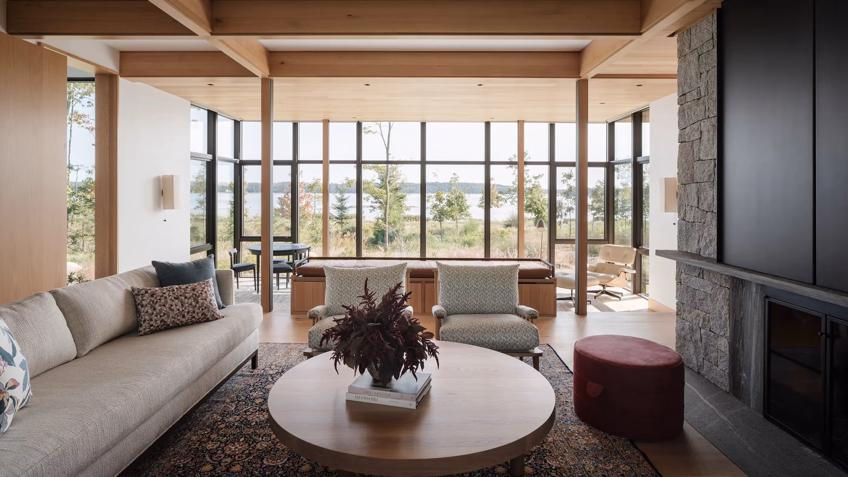 Modern living room with large windows overlooking scenic landscape and nature