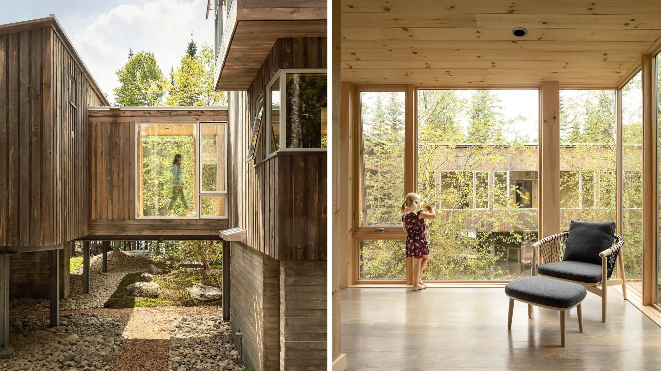 Wooden cabin with large windows overlooking forest, person near window