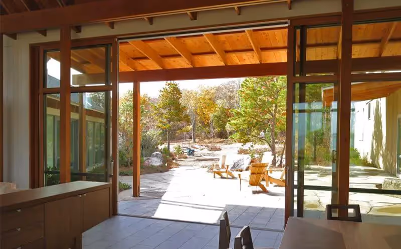 Bright indoor space with sliding glass doors opening to a serene garden patio