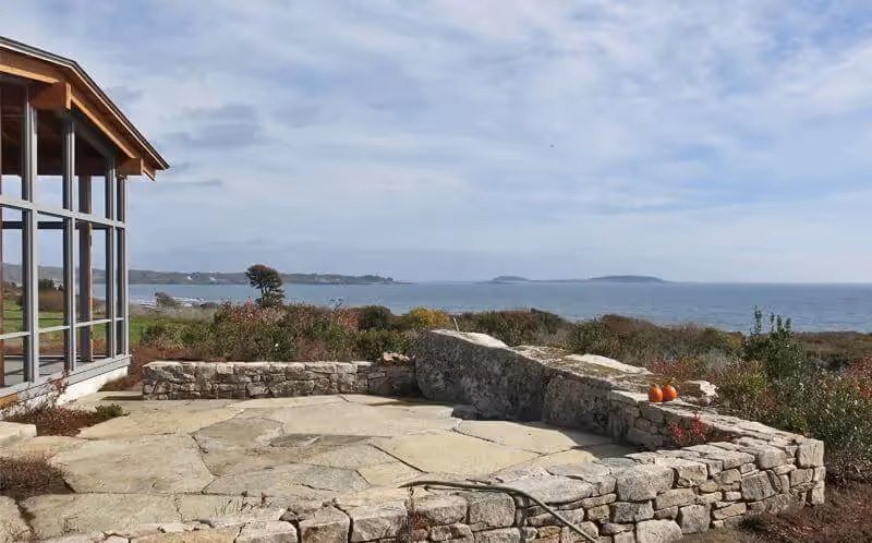 Stone patio overlooking coastal landscape with ocean and distant islands