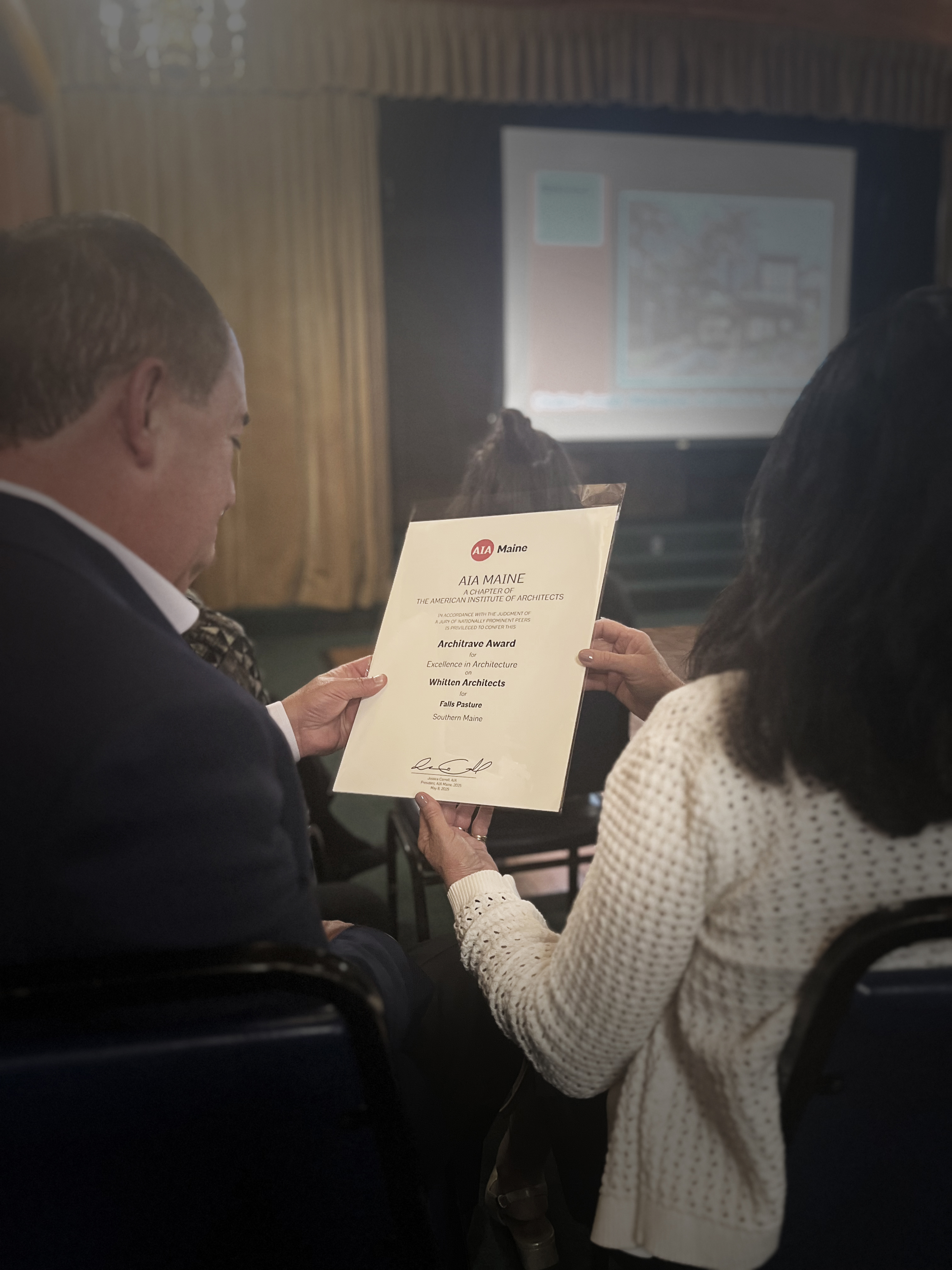 AIA Maine architecture award certificate being held at presentation ceremony